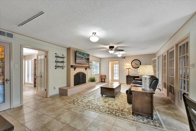18435 Point Lookout Dr, Houston, TX 77058 - tiled living room featuring a textured ceiling, a brick fireplace, and a ceiling fan
