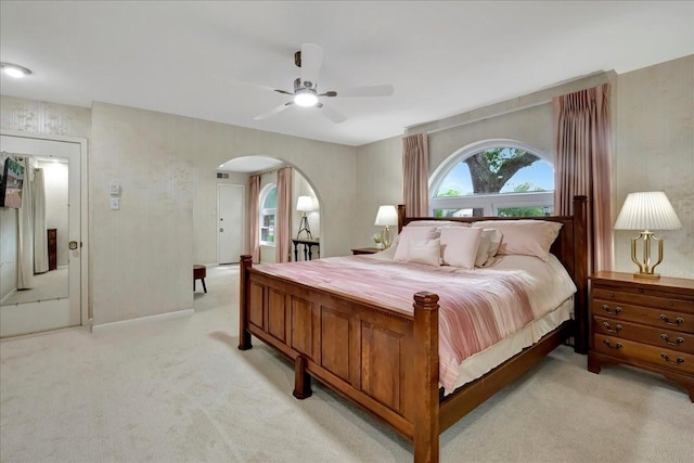 18435 Point Lookout Dr, Houston, TX 77058 - bedroom with arched walkways, light colored carpet, and a ceiling fan