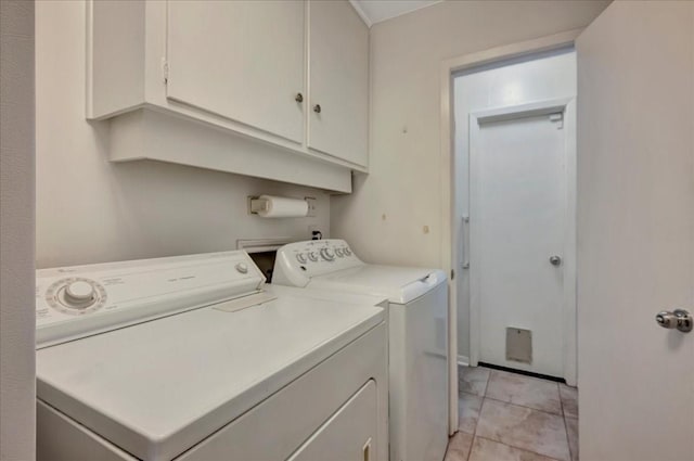 18435 Point Lookout Dr, Houston, TX 77058 - laundry room with washer and dryer, cabinet space, and light tile patterned floors