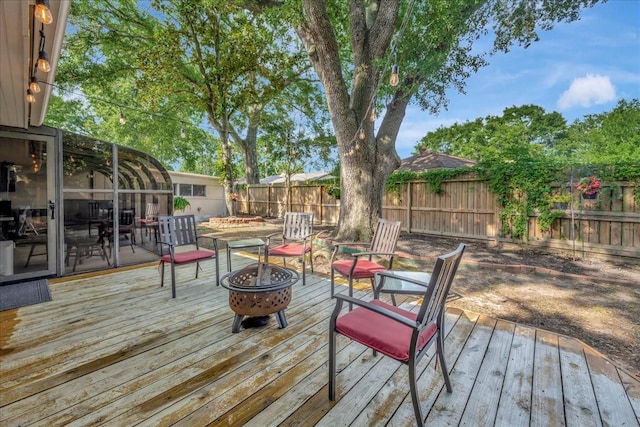 18435 Point Lookout Dr, Houston, TX 77058 - wooden deck with an outdoor fire pit and a fenced backyard