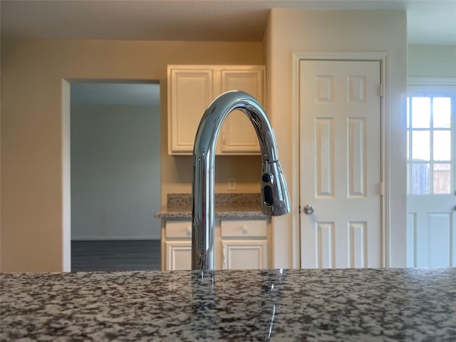 5918 Fergis Dr, Katy, TX 77449 - kitchen view of stone counters, white cabinetry, and wood finished floors
