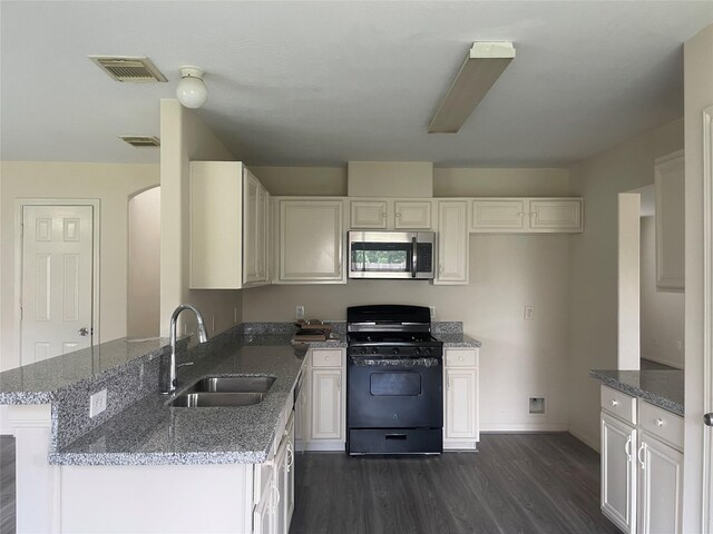 5918 Fergis Dr, Katy, TX 77449 - kitchen featuring a sink, black range with gas stovetop, stainless steel microwave, dark wood finished floors, and light stone countertops