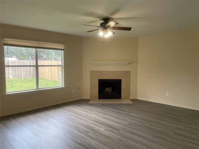 5918 Fergis Dr, Katy, TX 77449 - unfurnished living room featuring wood finished floors, ceiling fan, a fireplace, and baseboards