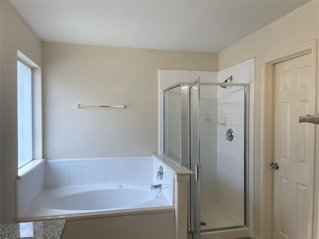 5918 Fergis Dr, Katy, TX 77449 - bathroom featuring healthy amount of natural light, a stall shower, and a bath