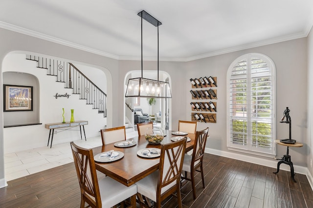 6203 Aspen Pass Dr, Kingwood, TX 77345 - dining space with arched walkways, stairway, dark wood-style flooring, baseboards, and crown molding
