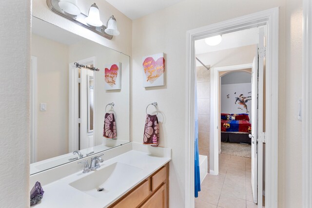 6203 Aspen Pass Dr, Kingwood, TX 77345 - full bath featuring tile patterned flooring, vanity, and ensuite bathroom