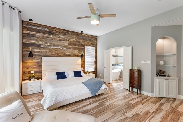 6203 Aspen Pass Dr, Kingwood, TX 77345 - bedroom featuring wooden walls, light wood-type flooring, ensuite bath, ceiling fan, and baseboards