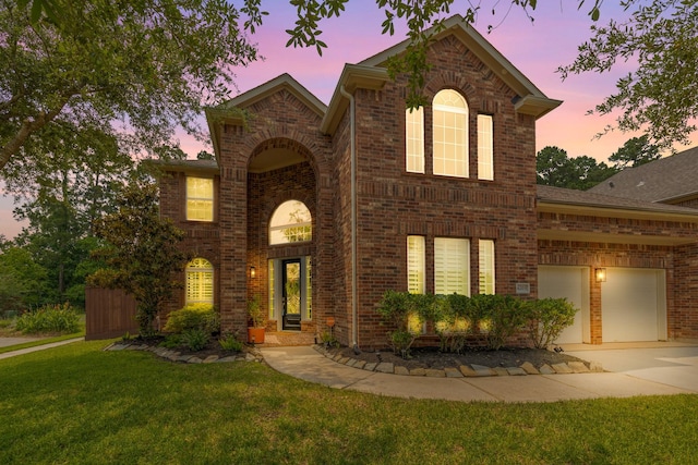 6203 Aspen Pass Dr, Kingwood, TX 77345 - traditional-style house featuring brick siding, driveway, a yard, and a garage