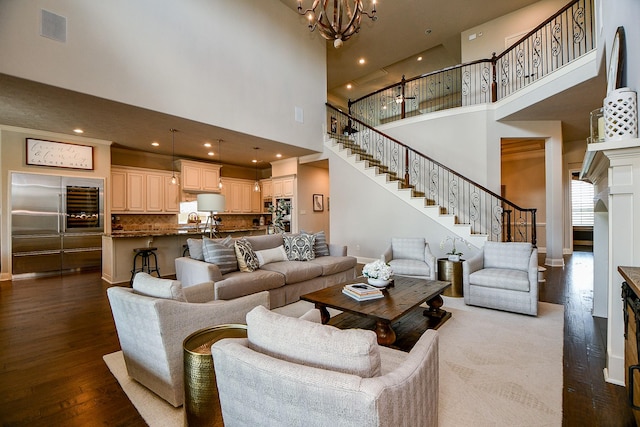 28011 Burnett Hills Ln, Fulshear, TX 77441 - living area featuring a towering ceiling, stairway, dark wood finished floors, a chandelier, and baseboards