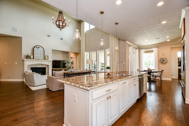 28011 Burnett Hills Ln, Fulshear, TX 77441 - kitchen with a sink, recessed lighting, dark wood-style flooring, light stone countertops, and baseboards