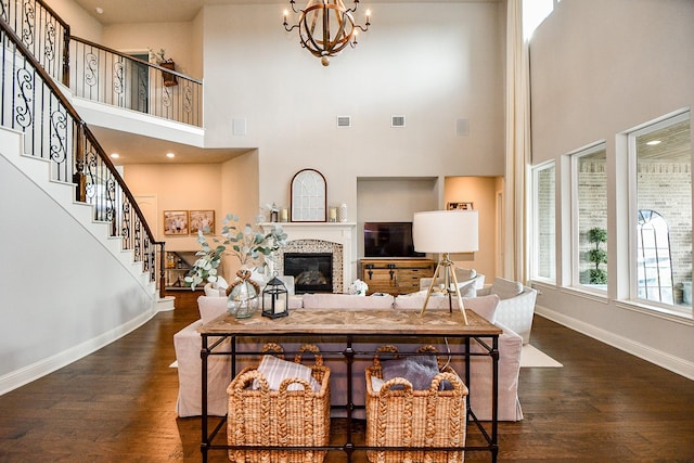 28011 Burnett Hills Ln, Fulshear, TX 77441 - living room featuring baseboards, dark wood-style floors, a tile fireplace, stairs, and a high ceiling