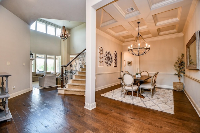 28011 Burnett Hills Ln, Fulshear, TX 77441 - dining area with a chandelier, healthy amount of natural light, a towering ceiling, wood finished floors, and coffered ceiling