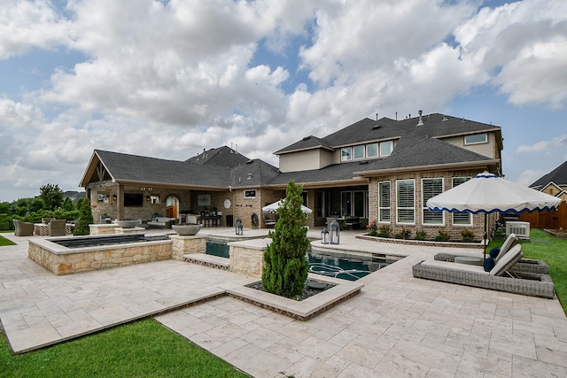 28011 Burnett Hills Ln, Fulshear, TX 77441 - rear view of house featuring a patio, an outdoor pool, and brick siding