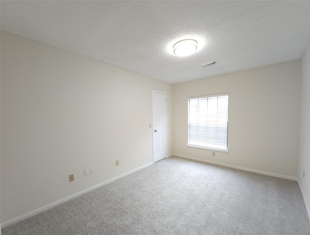 3226 Country Club Blvd, Stafford, TX 77477 - empty room with carpet floors, a textured ceiling, and baseboards