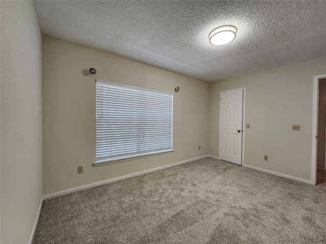 3226 Country Club Blvd, Stafford, TX 77477 - empty room with carpet flooring, baseboards, and a textured ceiling