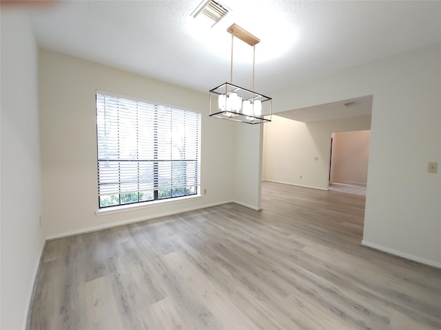 3226 Country Club Blvd, Stafford, TX 77477 - empty room with a chandelier, light wood-type flooring, and baseboards