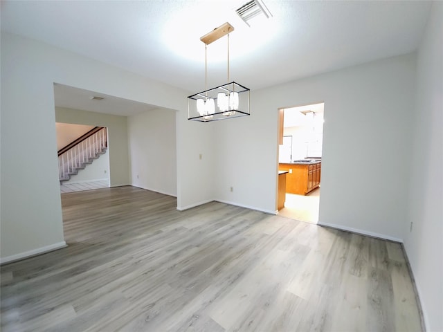 3226 Country Club Blvd, Stafford, TX 77477 - unfurnished dining area with stairway, light wood-style floors, a chandelier, and baseboards