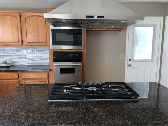 3226 Country Club Blvd, Stafford, TX 77477 - kitchen featuring appliances with stainless steel finishes, range hood, backsplash, and dark stone counters