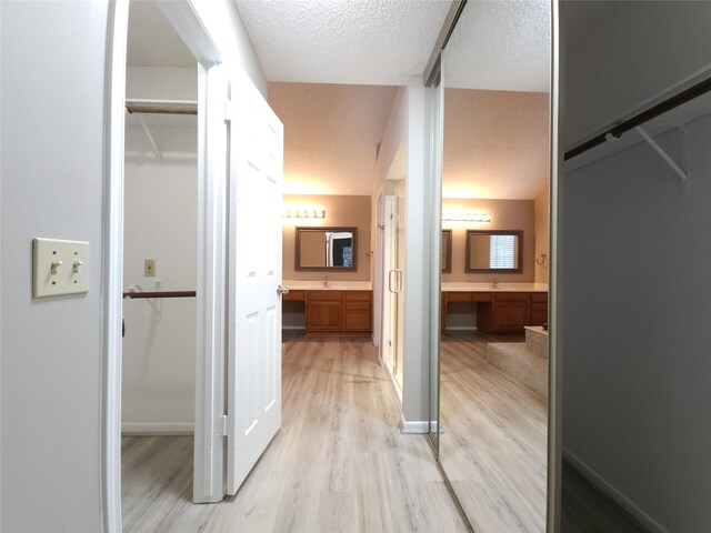 3226 Country Club Blvd, Stafford, TX 77477 - corridor featuring light wood-style floors and a textured ceiling