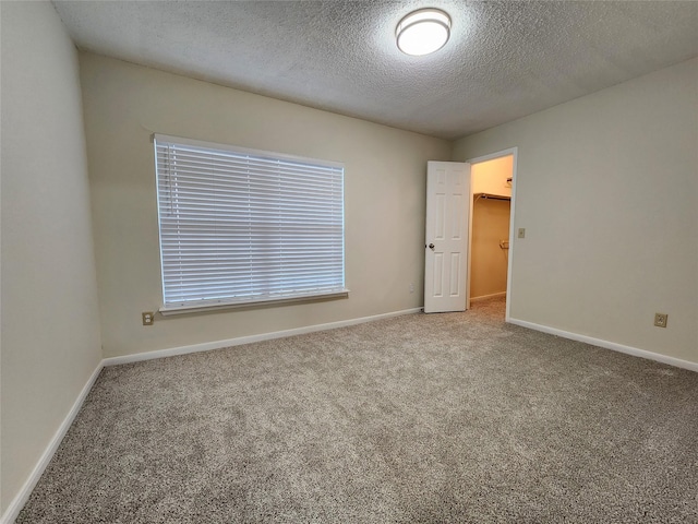 3226 Country Club Blvd, Stafford, TX 77477 - empty room with carpet floors, a textured ceiling, and baseboards