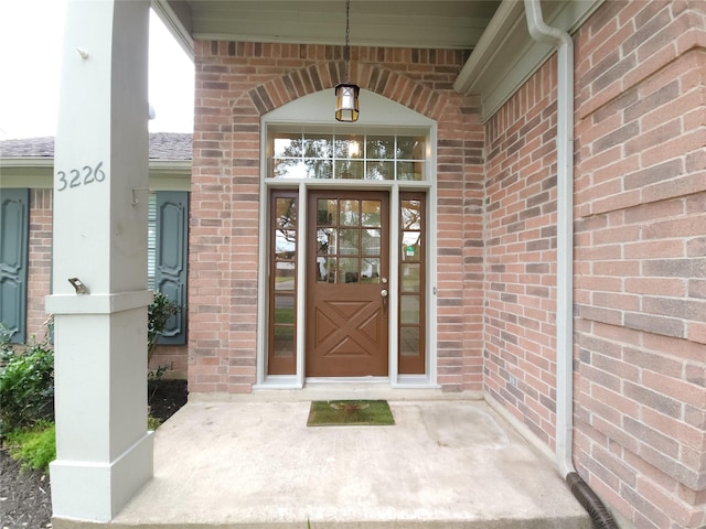 3226 Country Club Blvd, Stafford, TX 77477 - view of exterior entry with brick siding and roof with shingles