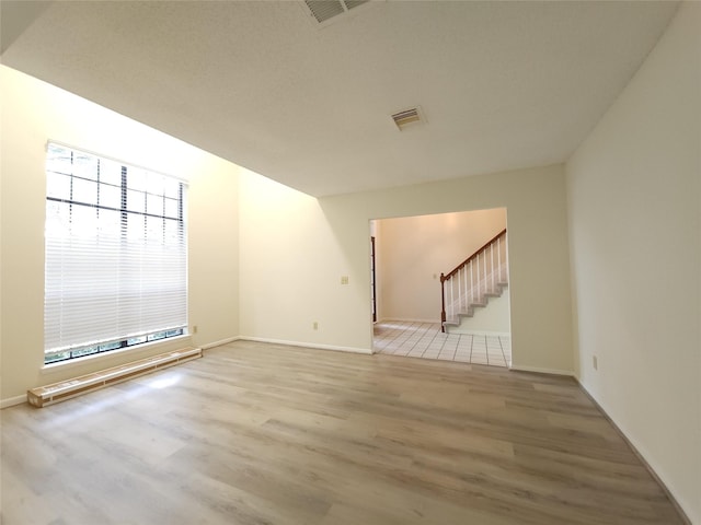 3226 Country Club Blvd, Stafford, TX 77477 - empty room featuring wood finished floors, stairway, and baseboards