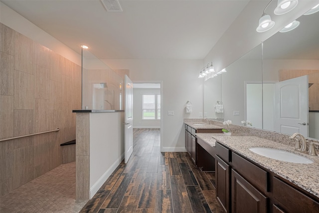 430 Seaside Sparrow Way, Richmond, TX 77469 - bathroom featuring wood finished floors, a walk in shower, vanity, and baseboards