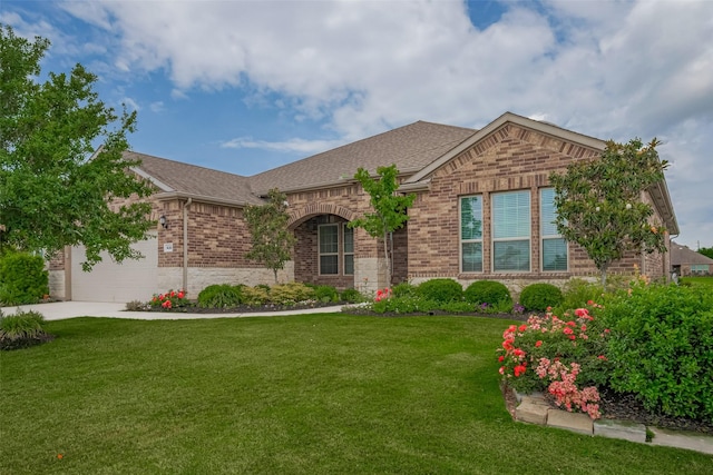 430 Seaside Sparrow Way, Richmond, TX 77469 - view of front of home with brick siding, an attached garage, a front lawn, a shingled roof, and concrete driveway