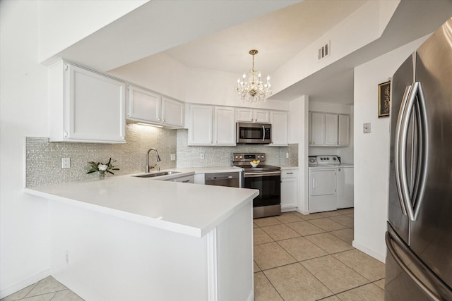 1111 Bering Dr Unit 301, Houston, TX 77057 - kitchen featuring stainless steel appliances, a sink, independent washer and dryer, a chandelier, and backsplash