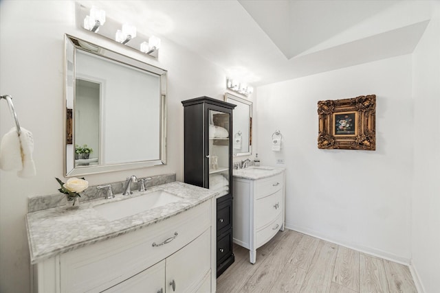 1111 Bering Dr Unit 301, Houston, TX 77057 - bathroom featuring two vanities and wood finished floors