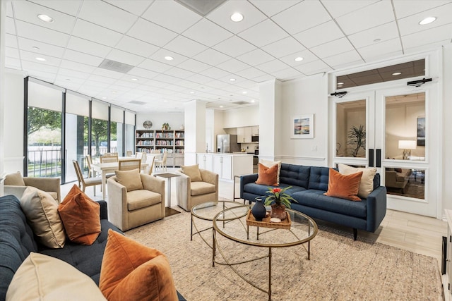 1111 Bering Dr Unit 301, Houston, TX 77057 - living area featuring light wood-style flooring, expansive windows, recessed lighting, and a drop ceiling