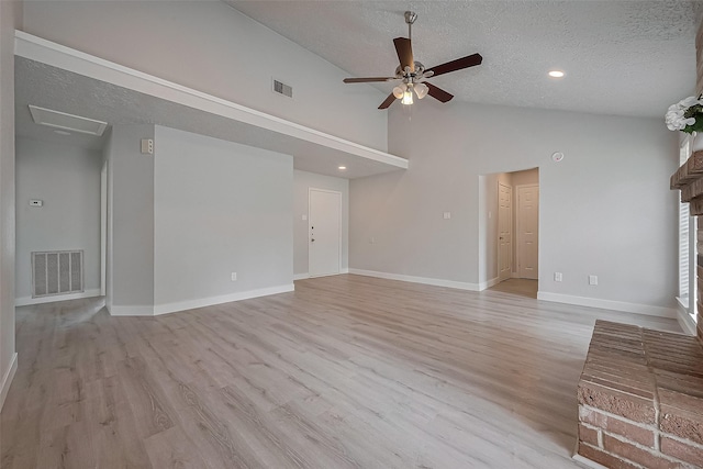 22010 Rivermead Dr, Katy, TX 77449 - unfurnished living room featuring a textured ceiling, a ceiling fan, light wood finished floors, baseboards, and high vaulted ceiling