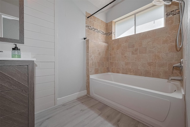 22010 Rivermead Dr, Katy, TX 77449 - full bath with wood finished floors, shower / bathtub combination, baseboards, and vanity
