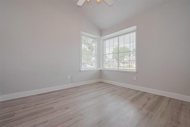 22010 Rivermead Dr, Katy, TX 77449 - empty room with lofted ceiling, a ceiling fan, light wood finished floors, and baseboards