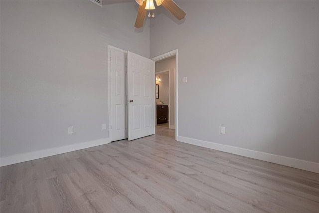 22010 Rivermead Dr, Katy, TX 77449 - unfurnished room featuring a ceiling fan, light wood-style flooring, baseboards, and a high ceiling