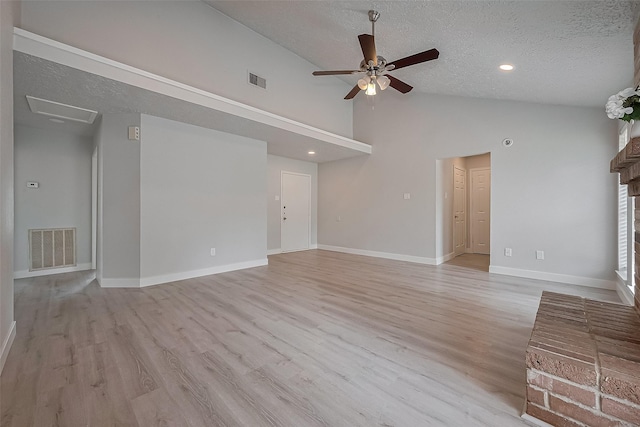 22010 Rivermead Dr, Katy, TX 77449 - unfurnished living room with a textured ceiling, a ceiling fan, light wood-type flooring, baseboards, and high vaulted ceiling