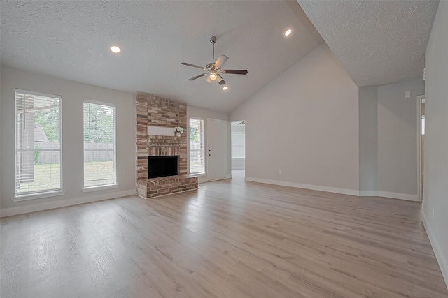 22010 Rivermead Dr, Katy, TX 77449 - unfurnished living room with a textured ceiling, baseboards, ceiling fan, light wood-type flooring, and healthy amount of natural light