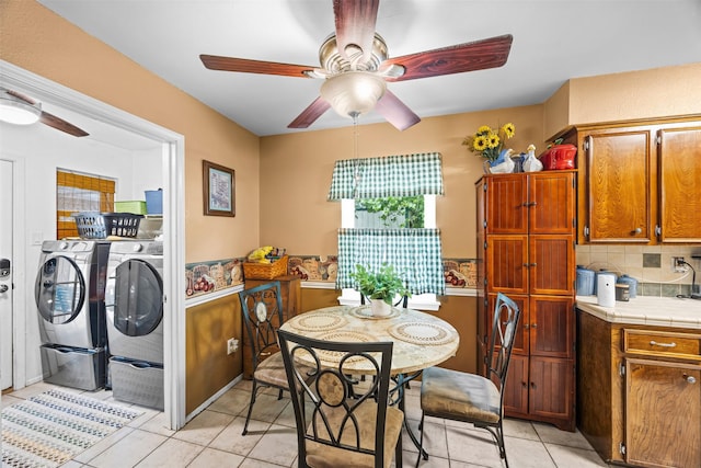 11855 23rd St, Santa Fe, TX 77510 - dining space with washing machine and clothes dryer, ceiling fan, and light tile patterned floors