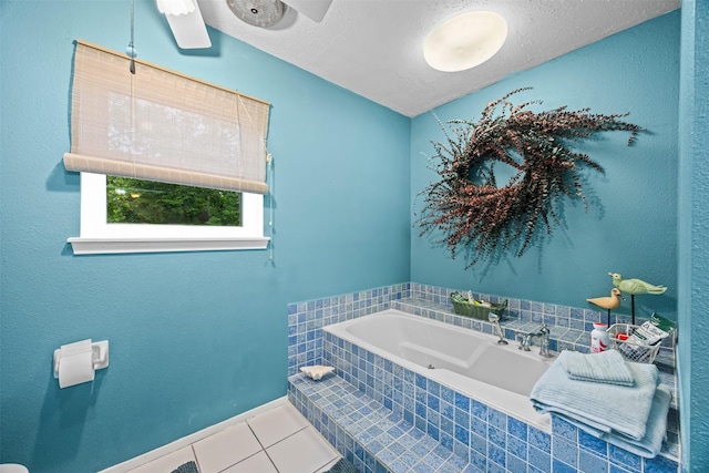 11855 23rd St, Santa Fe, TX 77510 - bathroom with tile patterned flooring, a bath, a textured ceiling, and baseboards