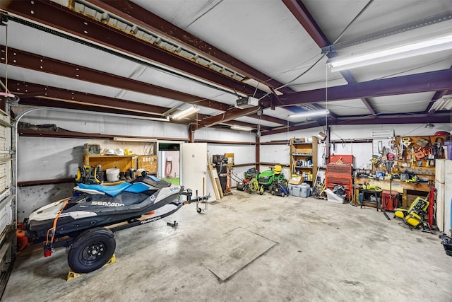 11855 23rd St, Santa Fe, TX 77510 - garage with a garage door opener and a workshop area