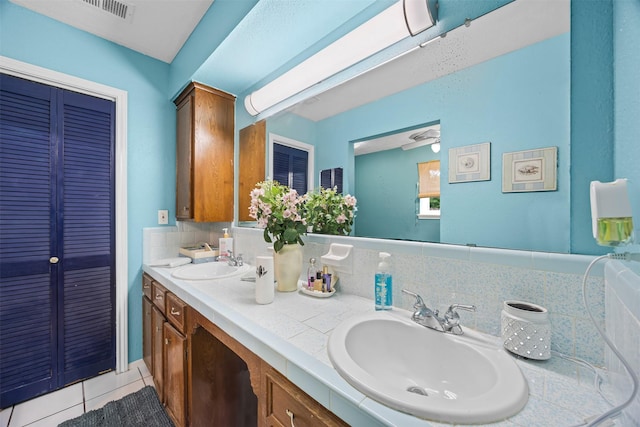 11855 23rd St, Santa Fe, TX 77510 - bathroom featuring tile patterned floors, double vanity, and a closet