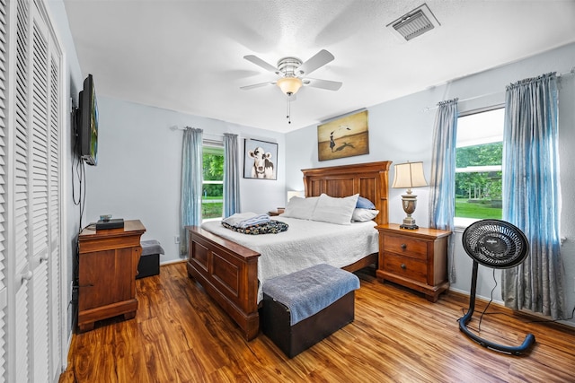 11855 23rd St, Santa Fe, TX 77510 - bedroom featuring wood finished floors, multiple windows, baseboards, and a ceiling fan