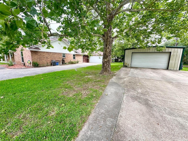 11855 23rd St, Santa Fe, TX 77510 - view of home's exterior featuring an outbuilding, a yard, a detached garage, and brick siding
