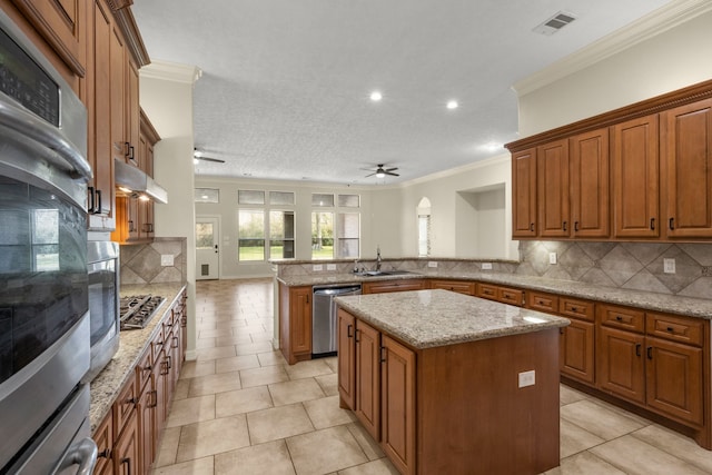 226 Beasley Reef Dr, Beach City, TX 77523 - kitchen featuring a ceiling fan, stainless steel appliances, a peninsula, a sink, and ornamental molding
