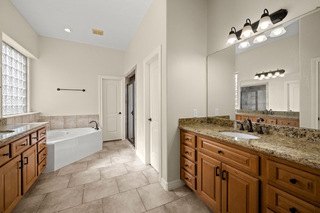 226 Beasley Reef Dr, Beach City, TX 77523 - bathroom with a stall shower, a garden tub, tile patterned flooring, and two vanities
