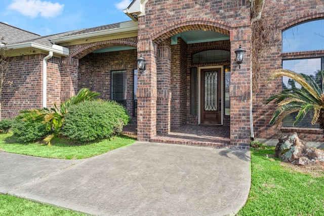 226 Beasley Reef Dr, Beach City, TX 77523 - property entrance featuring brick siding and a shingled roof
