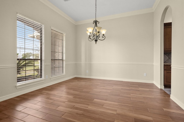 226 Beasley Reef Dr, Beach City, TX 77523 - spare room featuring arched walkways, a chandelier, wood finished floors, ornamental molding, and plenty of natural light