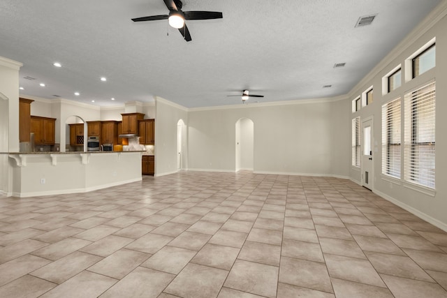 226 Beasley Reef Dr, Beach City, TX 77523 - unfurnished living room featuring ceiling fan, arched walkways, light tile patterned floors, recessed lighting, and crown molding