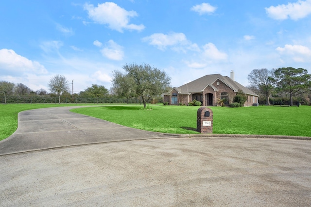 226 Beasley Reef Dr, Beach City, TX 77523 - single story home with a front yard, brick siding, and a chimney