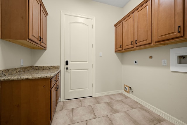 226 Beasley Reef Dr, Beach City, TX 77523 - laundry room featuring cabinet space, hookup for an electric dryer, baseboards, light tile patterned floors, and hookup for a washing machine